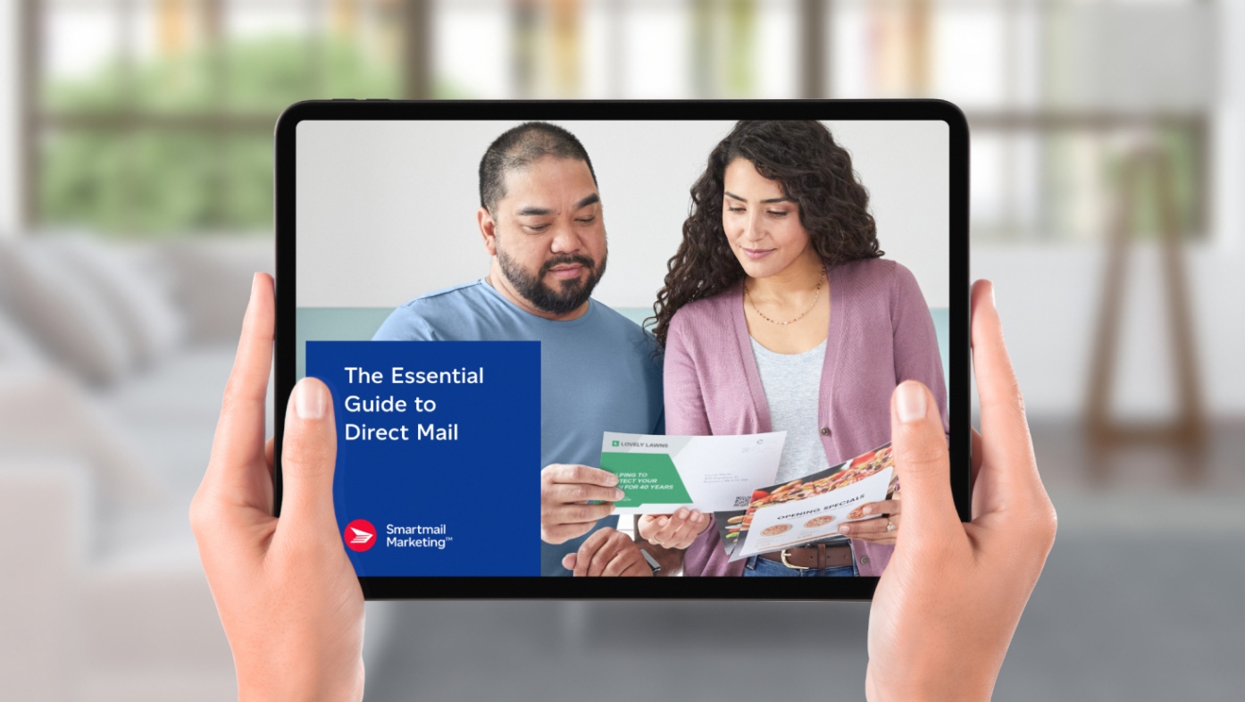 Close up of hands holding a tablet featuring Canada Post’s Essential Guide to Direct Mail